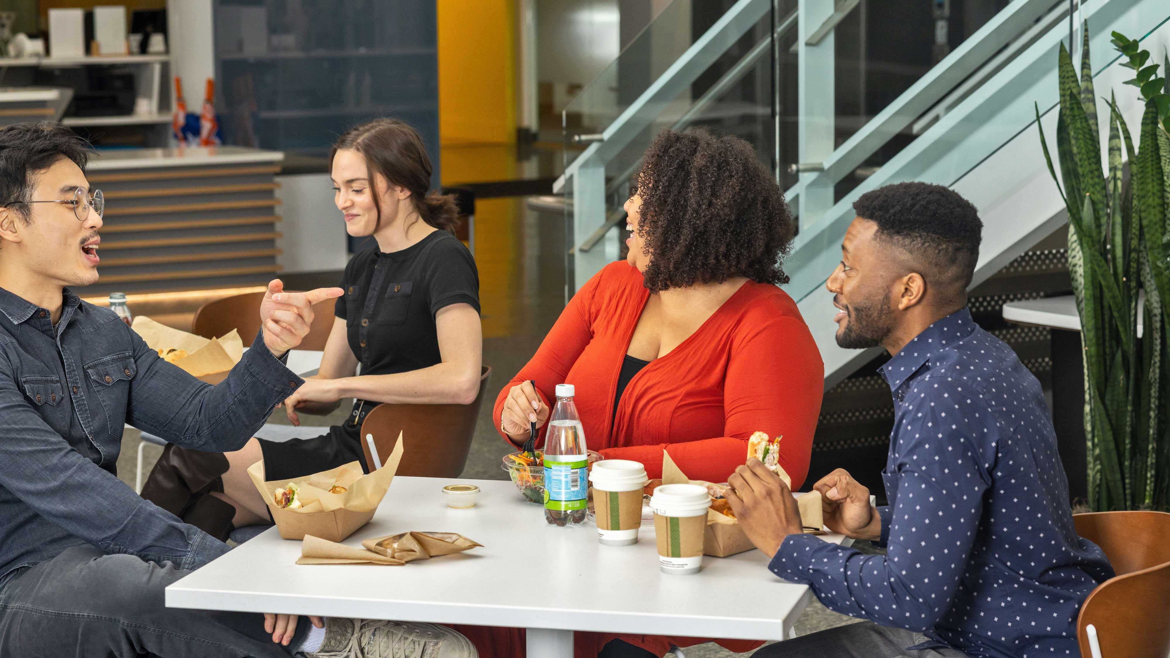 Group of people sitting in cafe enjoying food and conversation